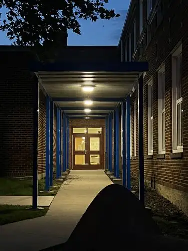 Warm light beckons from the quiet evening path.
